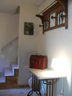 a suitcase sitting on a table next to a staircase at Can Seuba in Rellinars