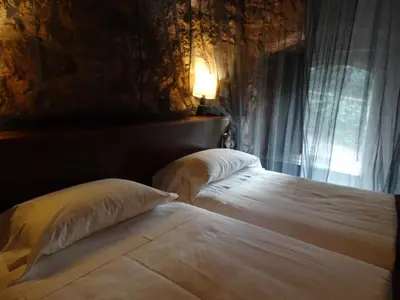 a bedroom with a bed with two pillows and a window at Can Seuba in Rellinars