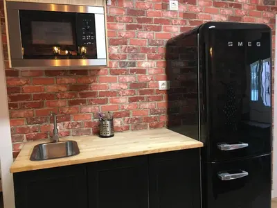 a kitchen with a black refrigerator and a microwave at Practical room: Barcelona-Fira-Airport in Hospitalet de Llobregat