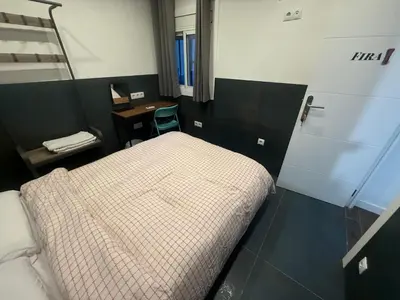 a small bedroom with a bed and a desk at Practical room: Barcelona-Fira-Airport in Hospitalet de Llobregat