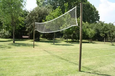 a volleyball net on a pole in a park at Agroturisme Can Burguès in Santa Eulalia de Ronsaná