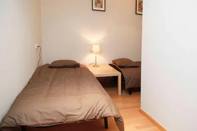 a bedroom with two beds and a table with a lamp at Sant Antoni Market in Barcelona
