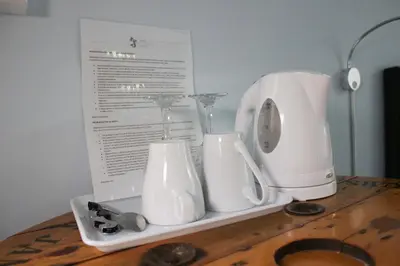 a shelf with two white appliances on a table at Hotel Alexandra Sitges in Sitges