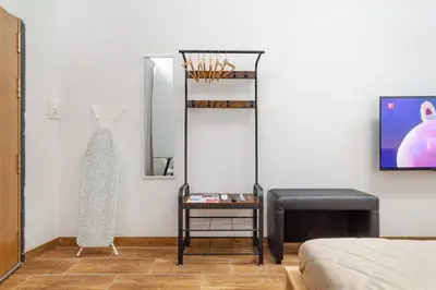a room with a bed and a table and a chair at CAMP NOU & FiRA BUSINESS LOFTS in Barcelona