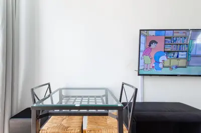 a glass table in a room with a tv at CAMP NOU & FiRA BUSINESS LOFTS in Barcelona
