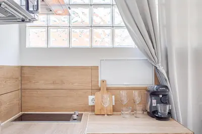 a kitchen with a counter with wine glasses on it at CAMP NOU & FiRA BUSINESS LOFTS in Barcelona