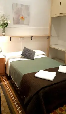 a bedroom with two beds with towels on them at Hostal Lima in Barcelona
