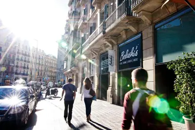 a group of people walking down a city street at St Christopher's Inn Barcelona in Barcelona