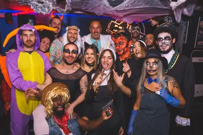 a group of people dressed in costumes posing for a picture at St Christopher's Inn Barcelona in Barcelona