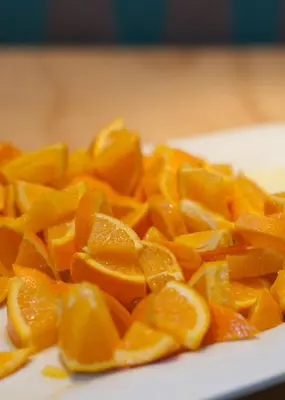 a pile of orange slices on a white plate at St Christopher's Inn Barcelona in Barcelona
