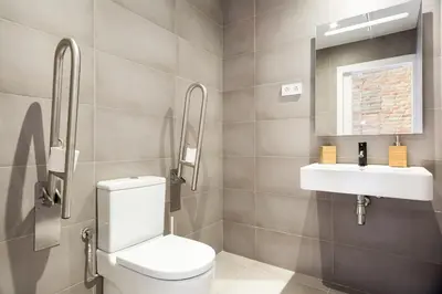 a bathroom with a toilet and a sink at Arte Suites by Olala! - Smart Stay in Hospitalet de Llobregat