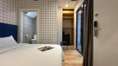 a bedroom with a bed with a book on it at Arte Suites by Olala! - Smart Stay in Hospitalet de Llobregat
