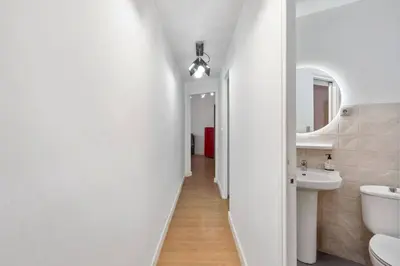 a white bathroom with a sink and a mirror at Quiet, Ultra-Central Stay KM0 for 3 in Barcelona