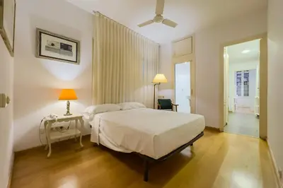 a bedroom with a bed and a desk and a window at ENRIQUE GRANADOS in Barcelona