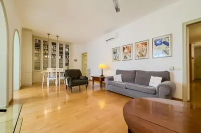 a living room with a couch and a chair at ENRIQUE GRANADOS in Barcelona