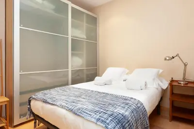 a bedroom with a bed with two pillows on it at ENRIQUE GRANADOS in Barcelona