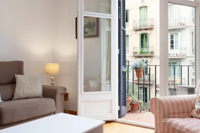 a living room with two couches and a window at ENRIQUE GRANADOS in Barcelona
