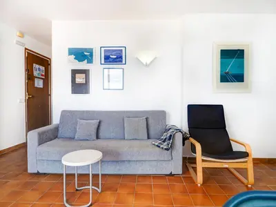 a living room with a couch and a chair at Amazing Seaview Apartment by Hello Homes Sitges in Sitges