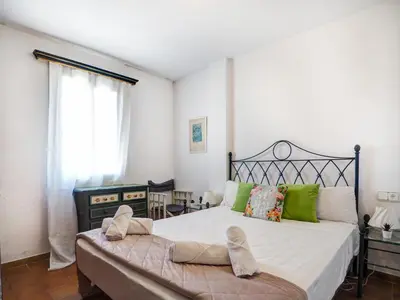 a bedroom with a large bed with green pillows at Amazing Seaview Apartment by Hello Homes Sitges in Sitges