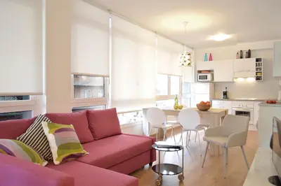 a living room with a red couch and a table at CIUDADELA PARK 1 in Barcelona