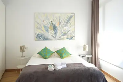a bedroom with a bed with two towels on it at CIUDADELA PARK 1 in Barcelona