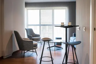a living room with chairs and a table at MH Apartments Urban in Barcelona
