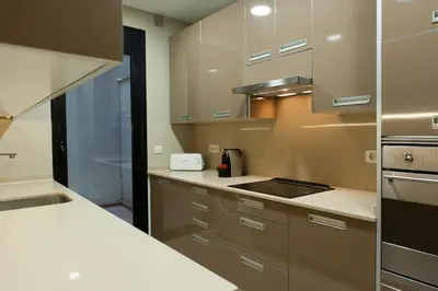 a kitchen with white counters and stainless steel appliances at MH Apartments Sant Pau in Barcelona