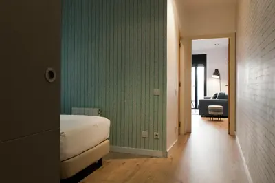 a bedroom with a bed and a green wall at MH Apartments Sant Pau in Barcelona