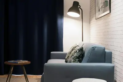 a living room with a blue couch and a table at MH Apartments Sant Pau in Barcelona