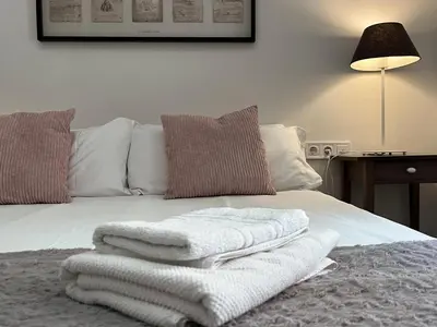 a bed with white towels sitting on top of it at CON GRACIA in Barcelona