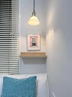 a bedroom with a blue pillow and a window at CON GRACIA in Barcelona