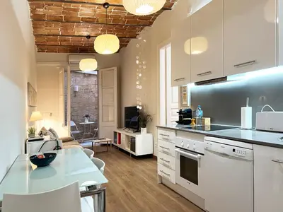 a kitchen with white cabinets and a counter top at CON GRACIA in Barcelona