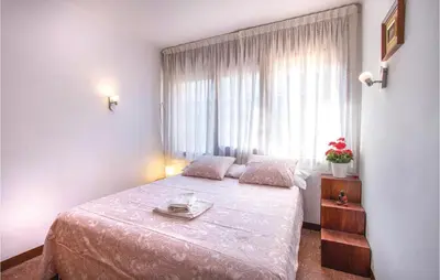 a bedroom with a bed and a window at Stunning Apartment In Pineda De Mar in Pineda de Mar