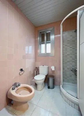 a pink bathroom with a toilet and a shower at Stay U-nique Apartments Calabria in Barcelona