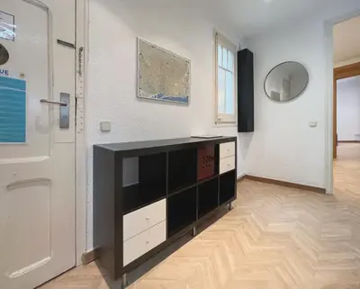 a room with a black and white dresser next to a door at Stay U-nique Apartments Calabria in Barcelona