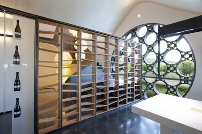 a room with a wall of wine racks at Mastinell Cava & Boutique Hotel by Olivia Hotels Collection in Vilafranca del Penedès