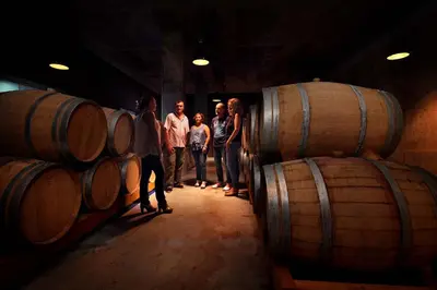 a group of people standing in a room with barrels at Mastinell Cava & Boutique Hotel by Olivia Hotels Collection in Vilafranca del Penedès