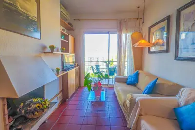 a living room with a couch and a fireplace at Aquamarine Terrace Apartment by Hello Homes Sitges in Sitges
