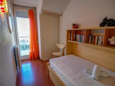 a small bedroom with a bed and a book shelf at Aquamarine Terrace Apartment by Hello Homes Sitges in Sitges