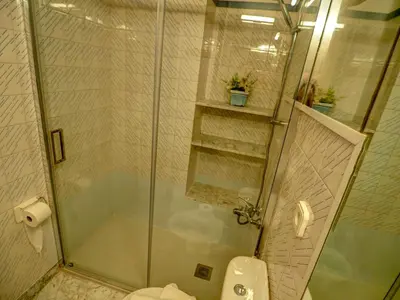 a bathroom with a shower and a toilet at Aquamarine Terrace Apartment by Hello Homes Sitges in Sitges