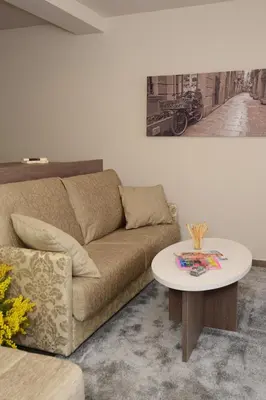 a living room with a couch and a table at Pierre & Vacances Barcelona Sants in Barcelona