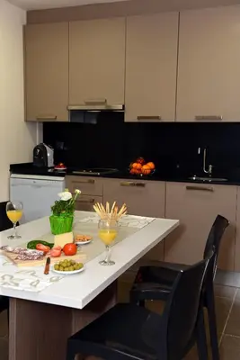 a kitchen with a table with food and drinks on it at Pierre & Vacances Barcelona Sants in Barcelona