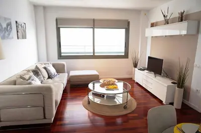 a living room with a couch and a coffee table at Happy Holiday Beach Home in Sitges
