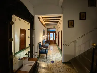 a hallway with chairs and tables in a building at Hotel Mitus in Canet de Mar