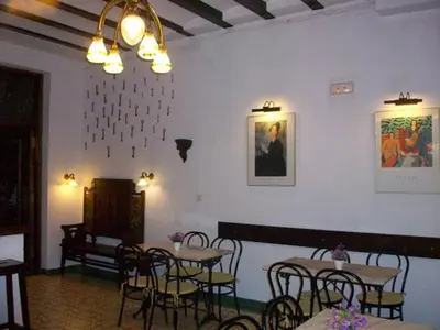 a restaurant with tables and chairs in a room at Hotel Mitus in Canet de Mar