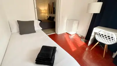 a bedroom with a bed and a table with a lamp at Des Artistes in Barcelona