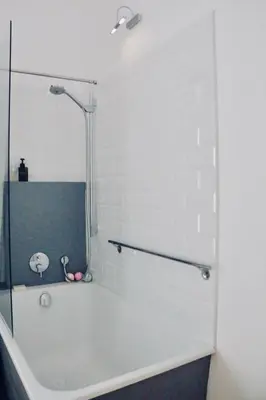 a white bathroom with a tub and a shower at La Casa Gran B&B in Barcelona