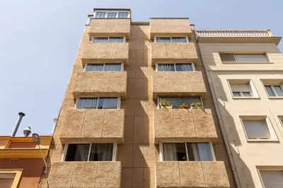 a tall building with windows and plants on it at Apartamentos Laforja in Barcelona
