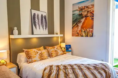 a bedroom with a bed with pillows on it at The Beach House Paradise by Hello Homes Sitges in Sitges