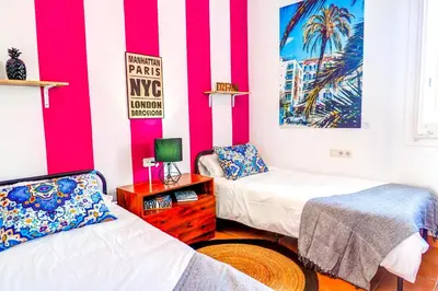 two beds in a room with red and white stripes at The Beach House Paradise by Hello Homes Sitges in Sitges